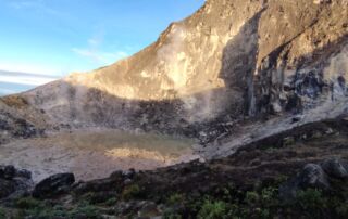 A italian couple tourist hiking to the mount sibayak volcano