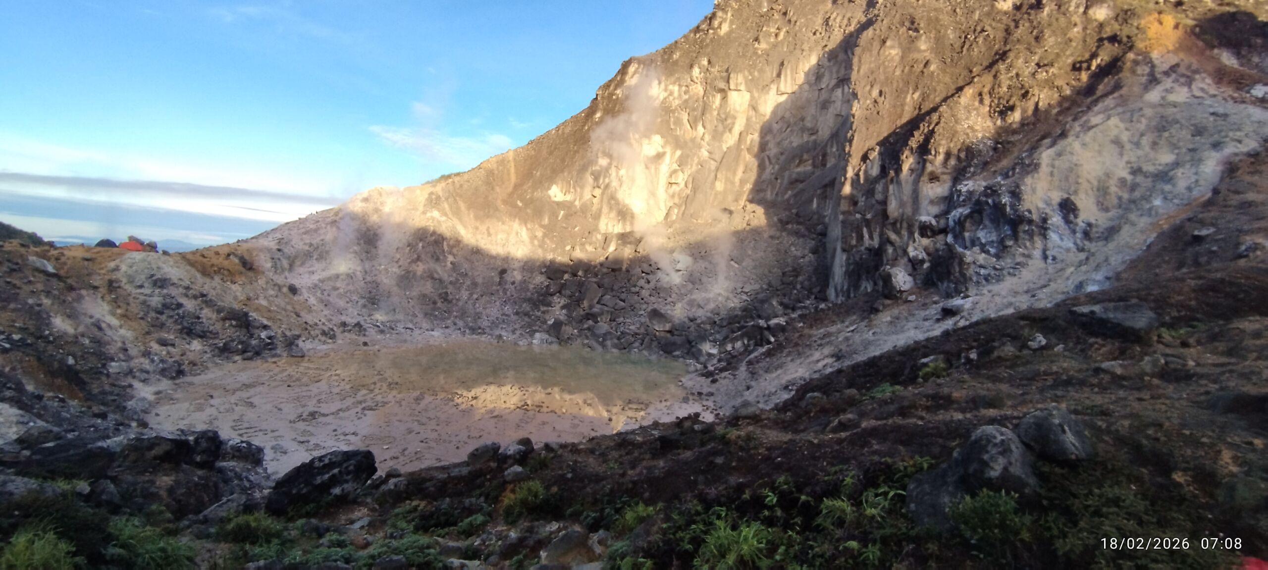 A italian couple tourist hiking to the mount sibayak volcano